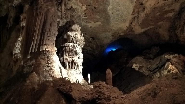 Below the blue light is a large pile of bat dung inside the Blanchard Springs Caverns.