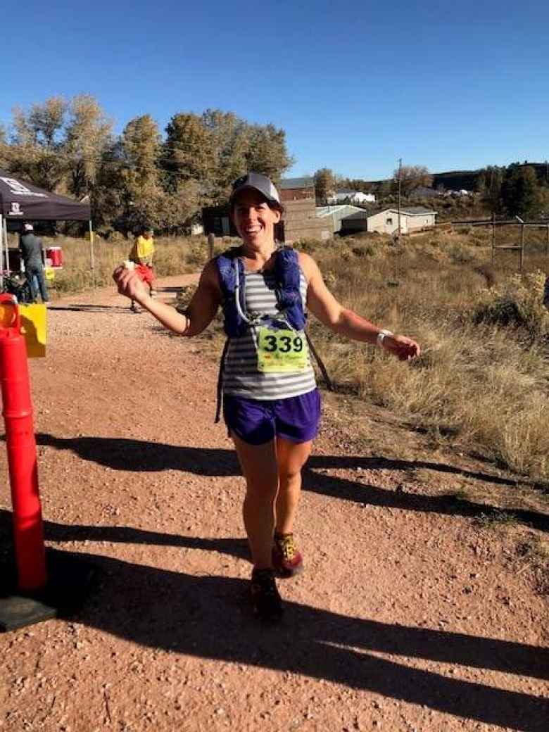 Jennifer after crossing the finish line of the 2018 Blue Sky Trail Marathon.