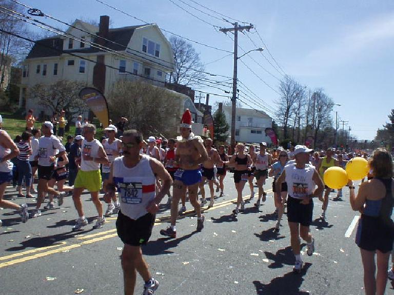 This photo was taken at Mile 17 but is pretty representative of the number of runners and size of the crowds.  I took the picture because of the guy wearing the funny hat.