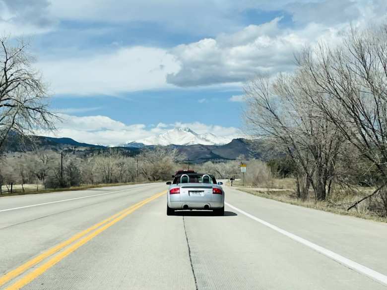 My silver Audi TT Roadster Quattro driving towards Longs Peak with the top down.