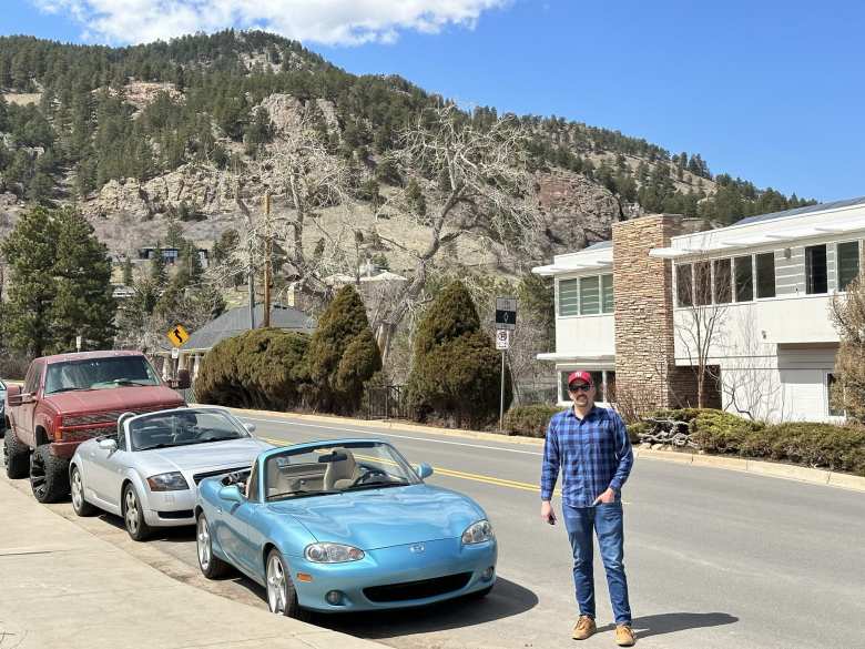 Manuel standing next to his Mazda Miata in front of a home near Boulder Mountain Park. My Audi TT Roadster is behind.