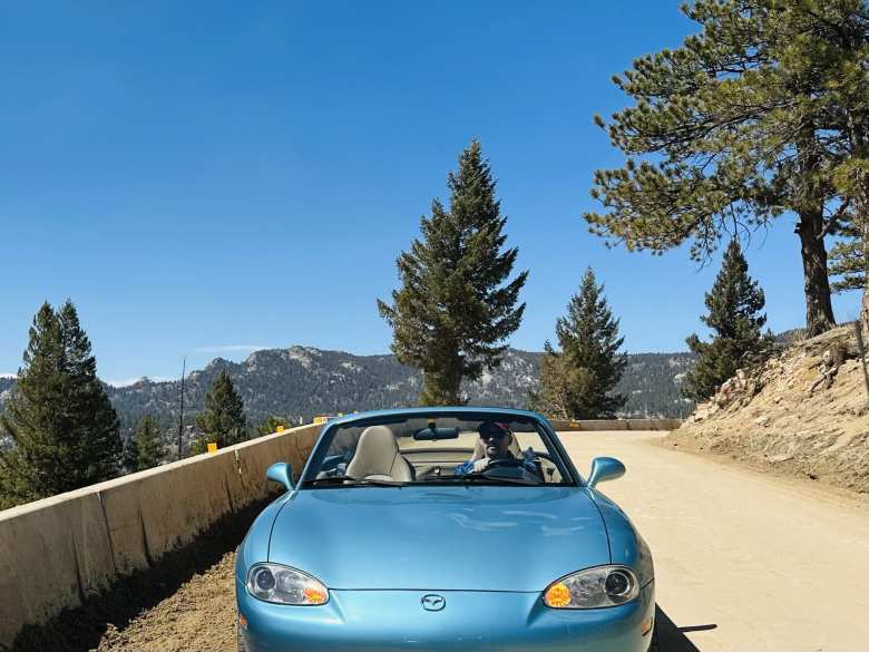 Manuel driving his Mazda Miata with the top down on the dirt and gravel Gross Dam Road, which connected Flagstaff Road to Highway 72.
