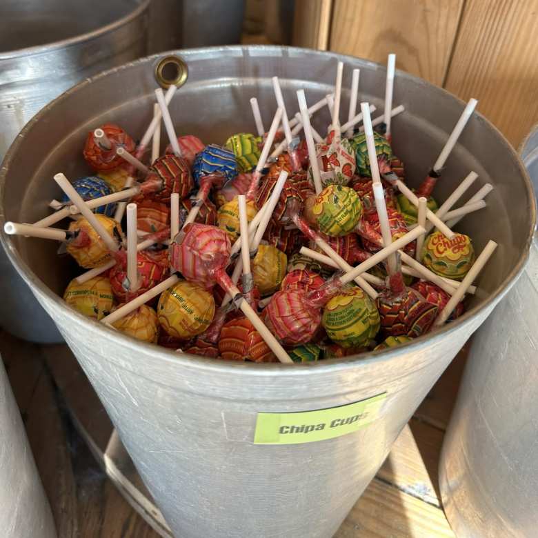 At a dessert store named Scrumptious in Longmont, Colorado, we encountered these Chupa Chups lolipops from Spain. The bucket they were in mistakenly called them "Chipa Cups."