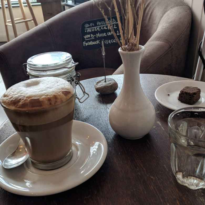 The barista at the Muse Café in Brighton and Cove brought me a glass of water, chocolate morsel, and wi-fi code along with a latte when I ordered the coffee. Really good service!