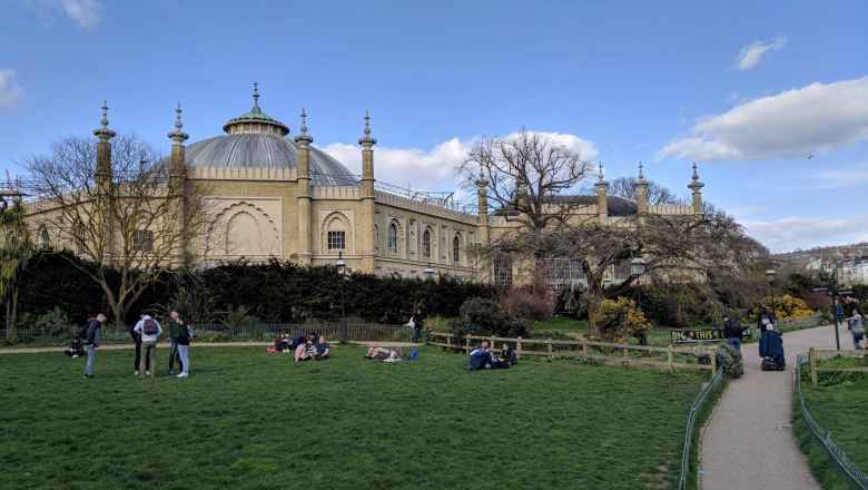 People hanging out at the Pavilion Gardens in Brighton and Cove.