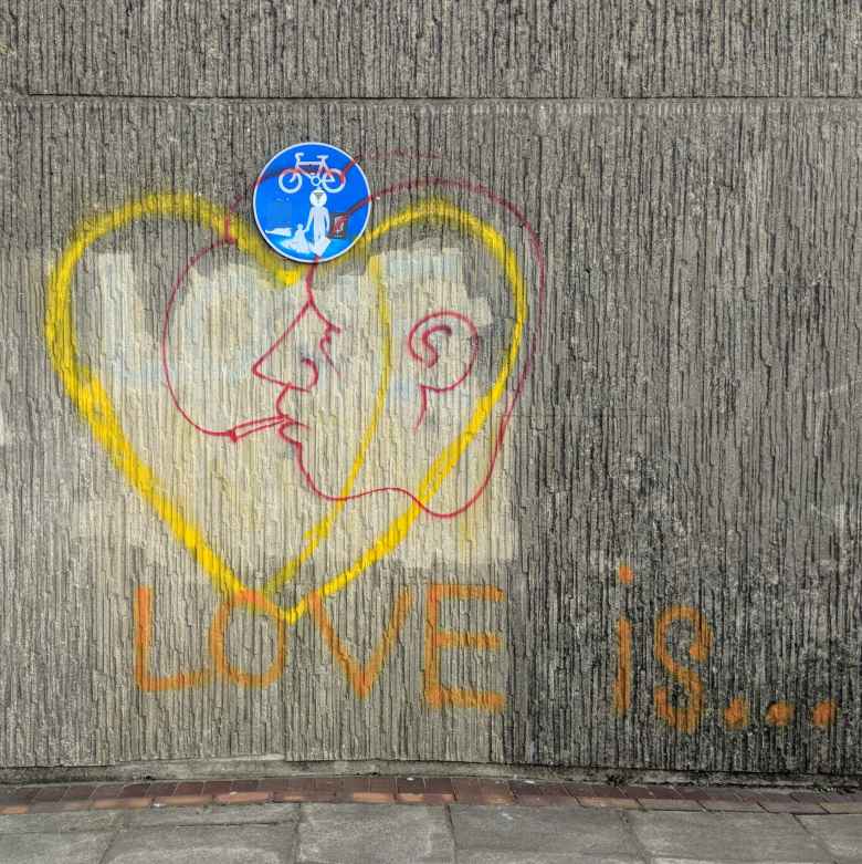 "Love is..." graffiti near the coast in Brighton and Cove.