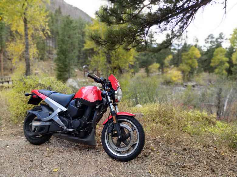 Red Buell Blast in the Poudre Canyon and fall colors behind.