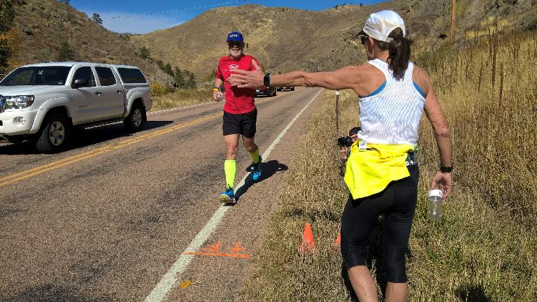 Bob Kennedy, the organizer and oldest finisher of the 2016 Cache La Poudre Marathon, being greeted by Connie DeMercurio as he crosses the finish line.