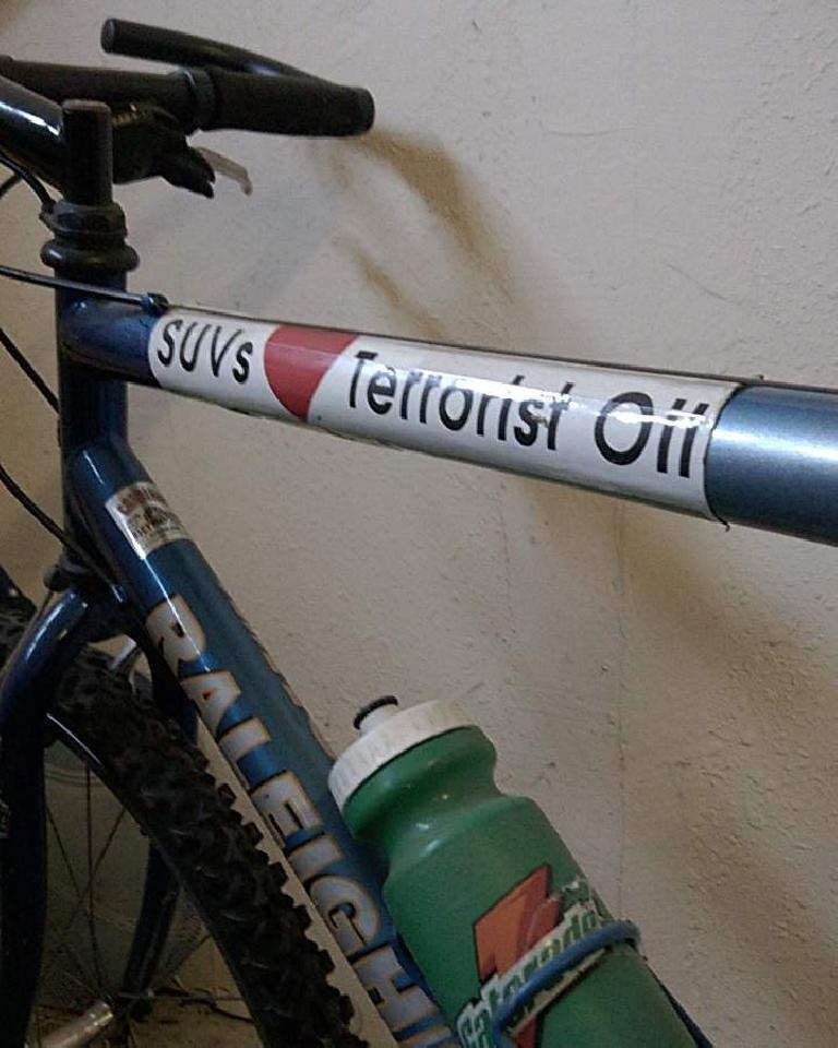 blue Raleigh mountain bike, SUVs love Terrorist Oil bumper sticker