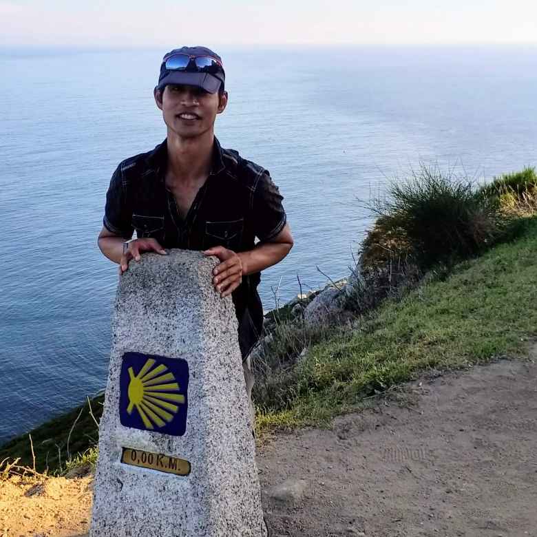 Felix Wong by the Kilometer 0.00 marker of the Camino de Santiago/Camino de Fisterra. The walk across the entire country of Spain was complete!