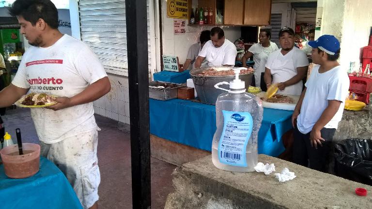 Mexicans selling and eating tacos in Cancún