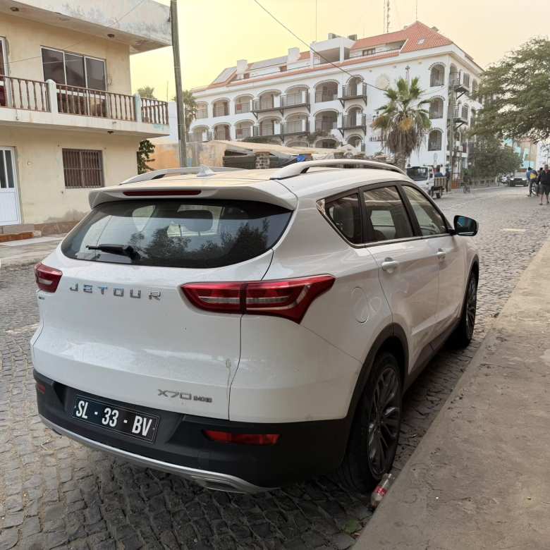 A white Jetour X70 crossover.