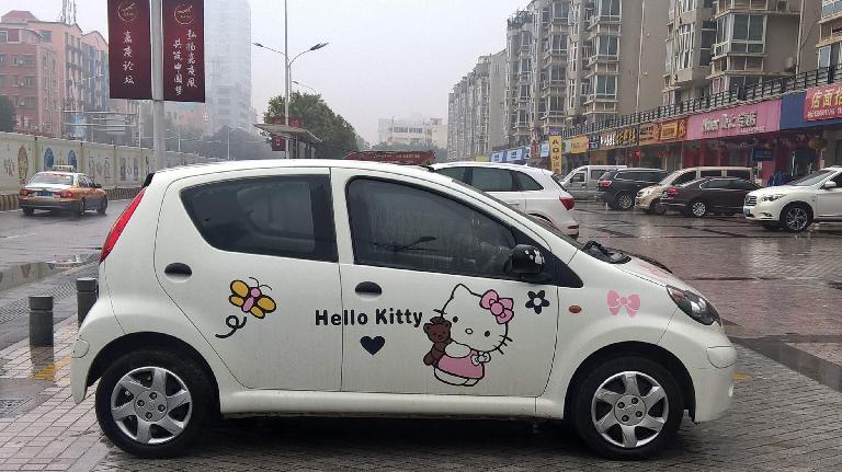 A white BYD F0 hatchback with Hello Kitty decals in Xiamen, China.