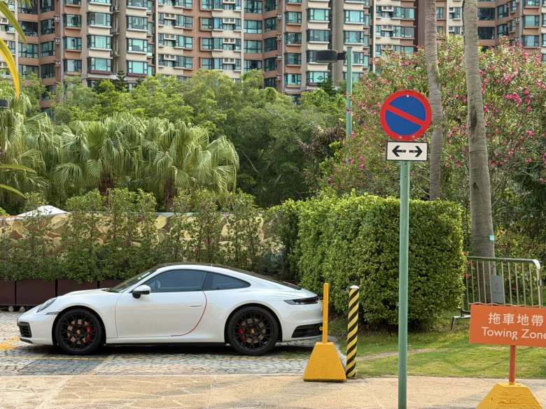 A white Porsche 911 with red door protector in Hong Kong.