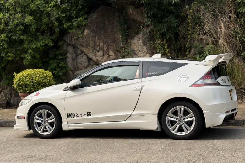 A white Honda CR-Z hybrid coupe (2010-2016) featuring a tribute to the legendary anime Initial D, with the 