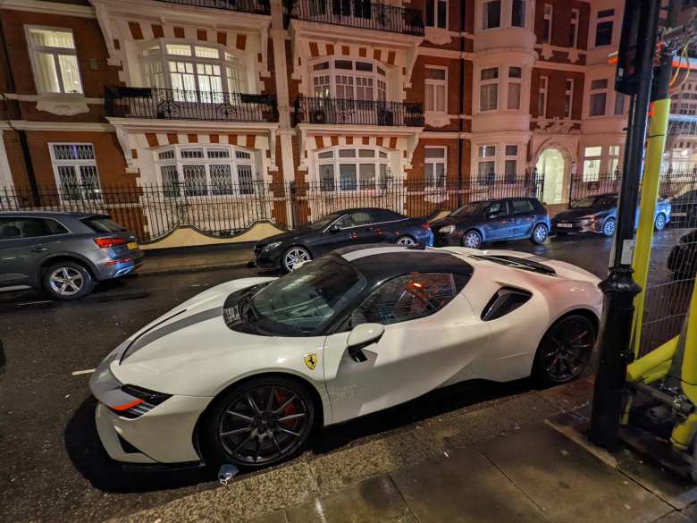 A white Ferrari SF90 Spider on the streets of London.