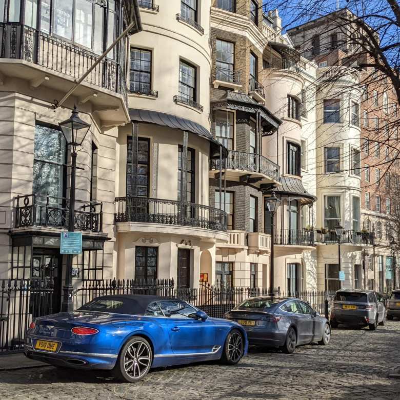 A blue Bentley Continental convertible near Hyde Park in London.