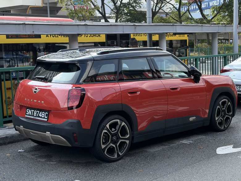 An orange electric MINI Aceman that is not available in the U.S.