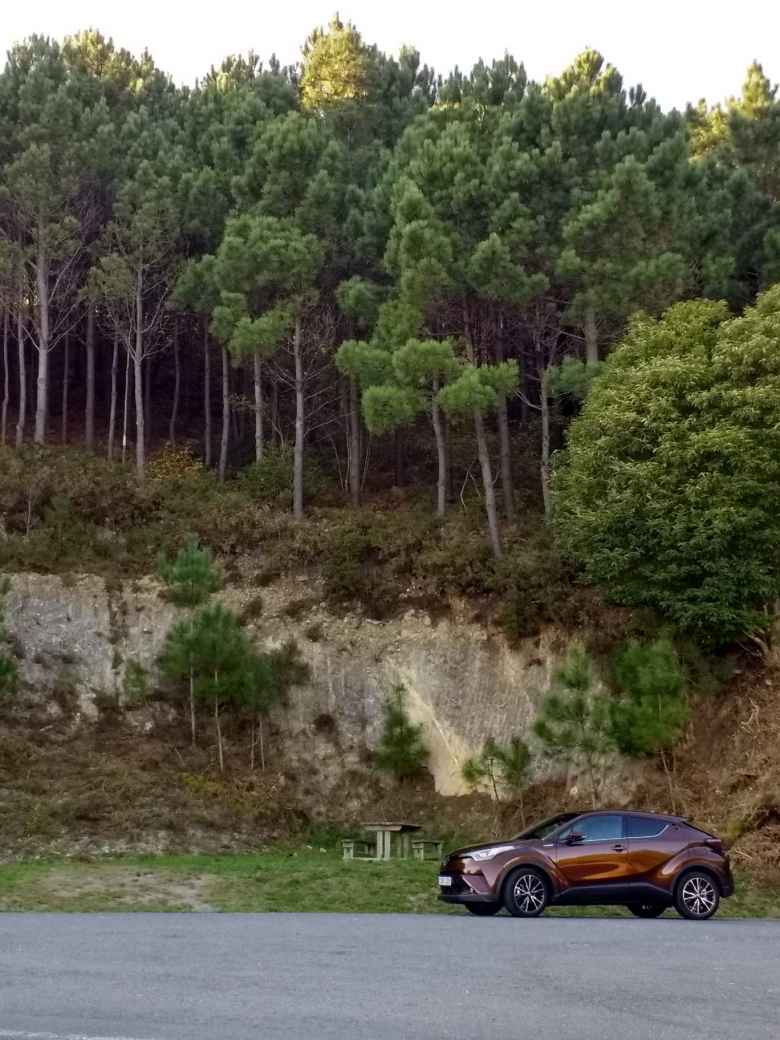 A maroon Toyota CH-R hybrid in Fisterra, Spain.