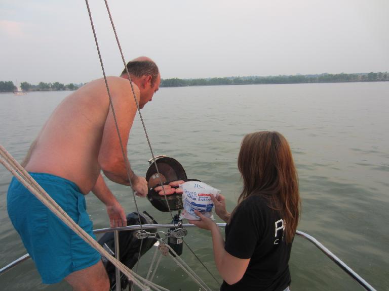 Keith grilling some hamburgers with a makeshift spatula that was a flat screwdriver.