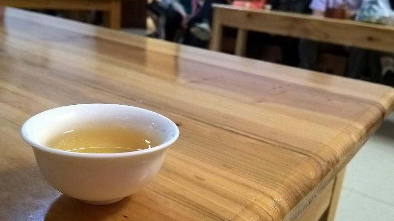 A cup of Oolong tea served by a Chinese tea house.
