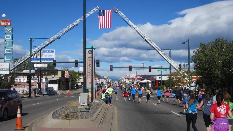 The U.S. flag above runners on Colfax Avenue at the 2015 Colfax Half Marathon. U.S. flag, runners on Colfax Ave., 2015 Colfax Half Marathon