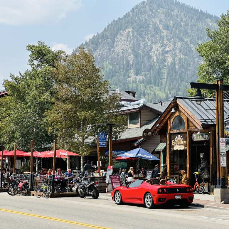 A red Ferrari 360 Spider in front of the Frisco Emporium, a conglomerate of shops in a wood-centric environment. A red Ferrari 360 Spider in front of the Frisco Emporium, a conglomerate of shops in a wood-centric environment.