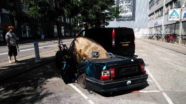 Yikes!  Car crushed by a rock.