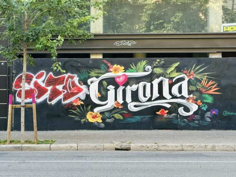 A colorful mural that says Girona.