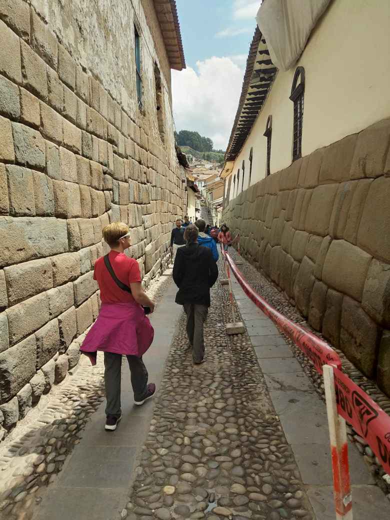 Walking down an alley featuring Inca stonework.