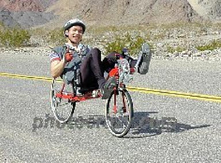 Felix Wong riding a Reynolds Wishbone recumbent in the 2000 Death Valley Double Century. Photo: photocrazy.com. Felix Wong riding a red Reynolds Wishbone recumbent, 2000 Death Valley Double Century