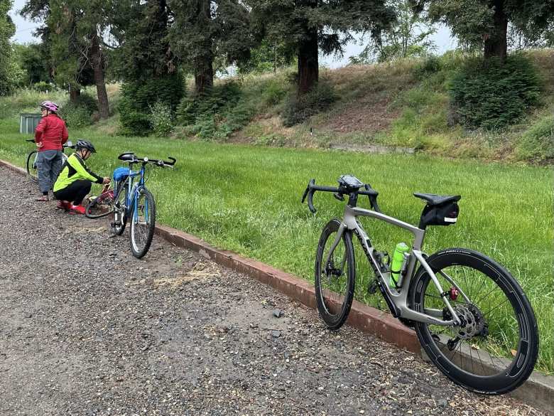 A cyclist discovered a flat tire as he was leaving the first rest stop. Also shown is my Raleigh M30 and a Grey Pinarello F.