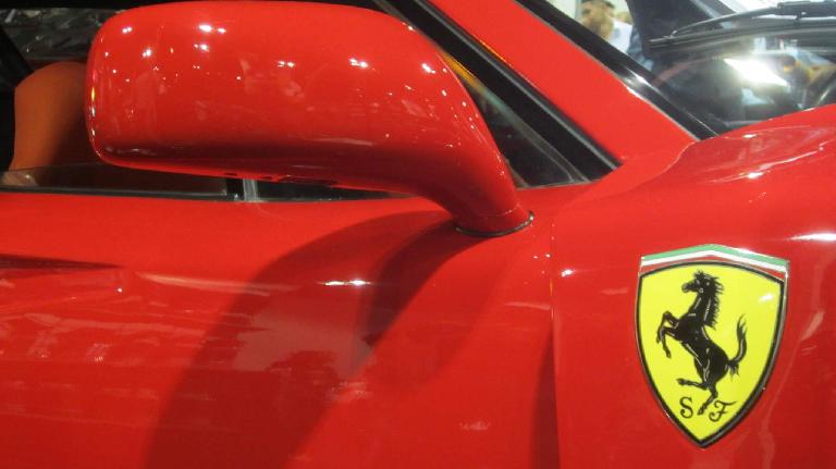 yellow Ferrari badge on red Ferrari F40