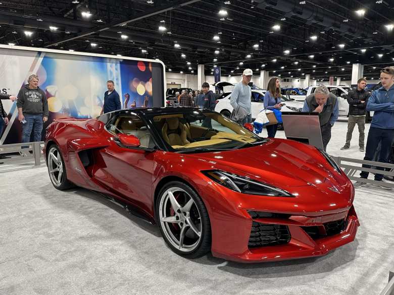 A red Corvette C8 eRay. It is powered by gasoline and electric motors.