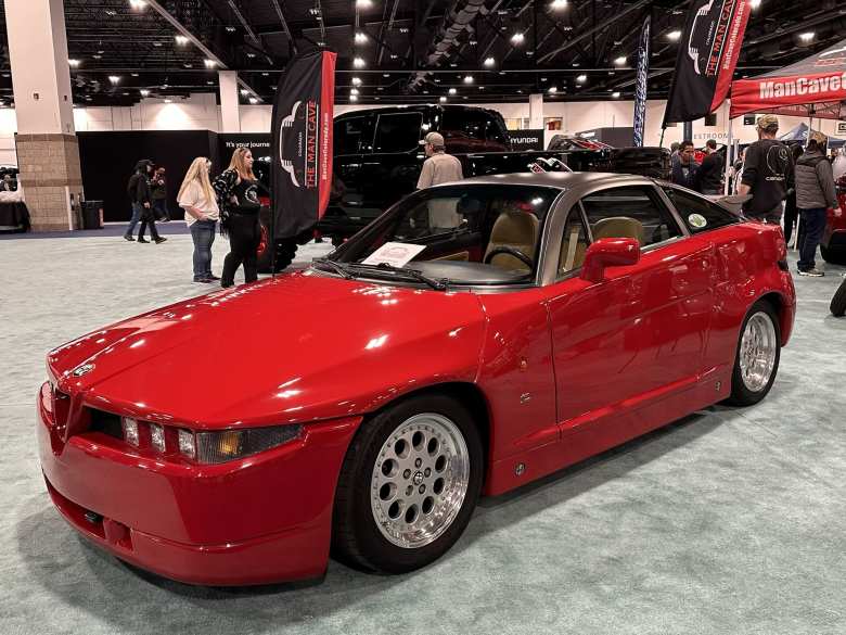 A red Alfa Romeo SZ. It was built by Zagato around 1990.