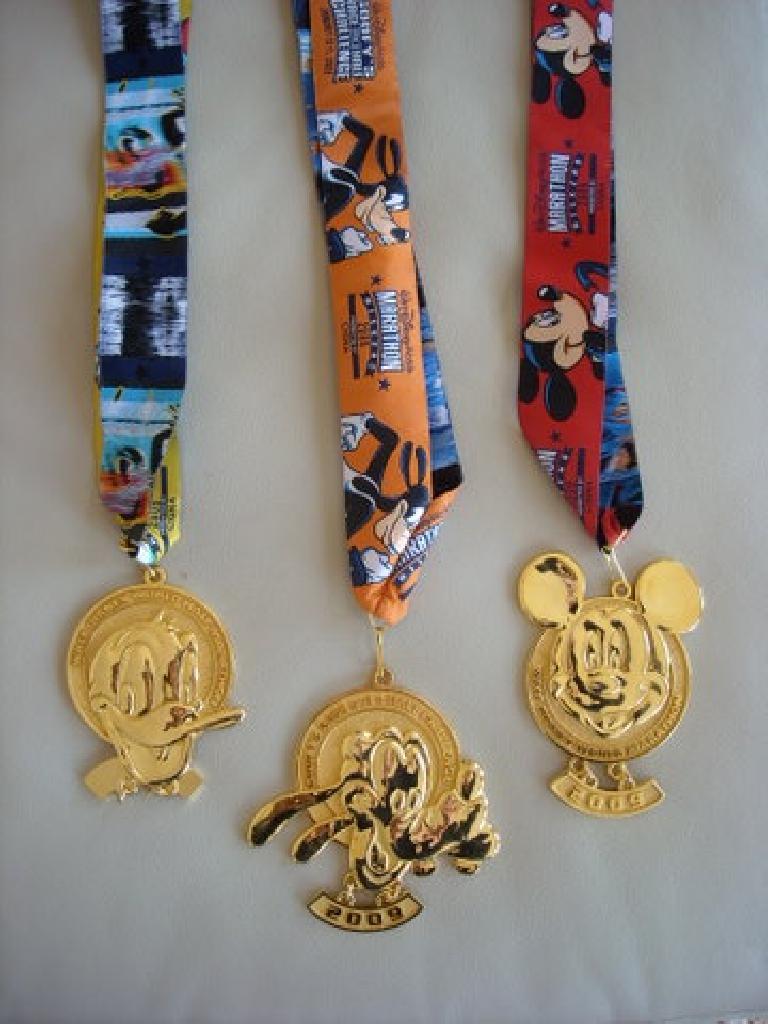 Medals from the Disney World Half Marathon, Goofy's Race-and-a-Half Challenge, and full marathon.