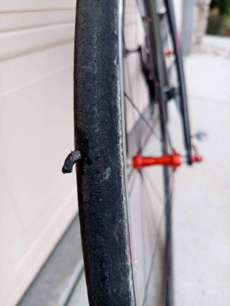 A Dynaplug Racer tire plug plugging a puncture in a Hutchinson Fusion 3 tubeless road tire.
