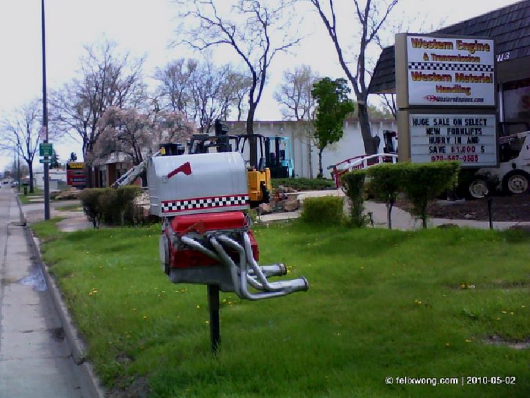 mailbox with exhaust manifolds on it outside Western Engines &amp; Transmissions repair shop