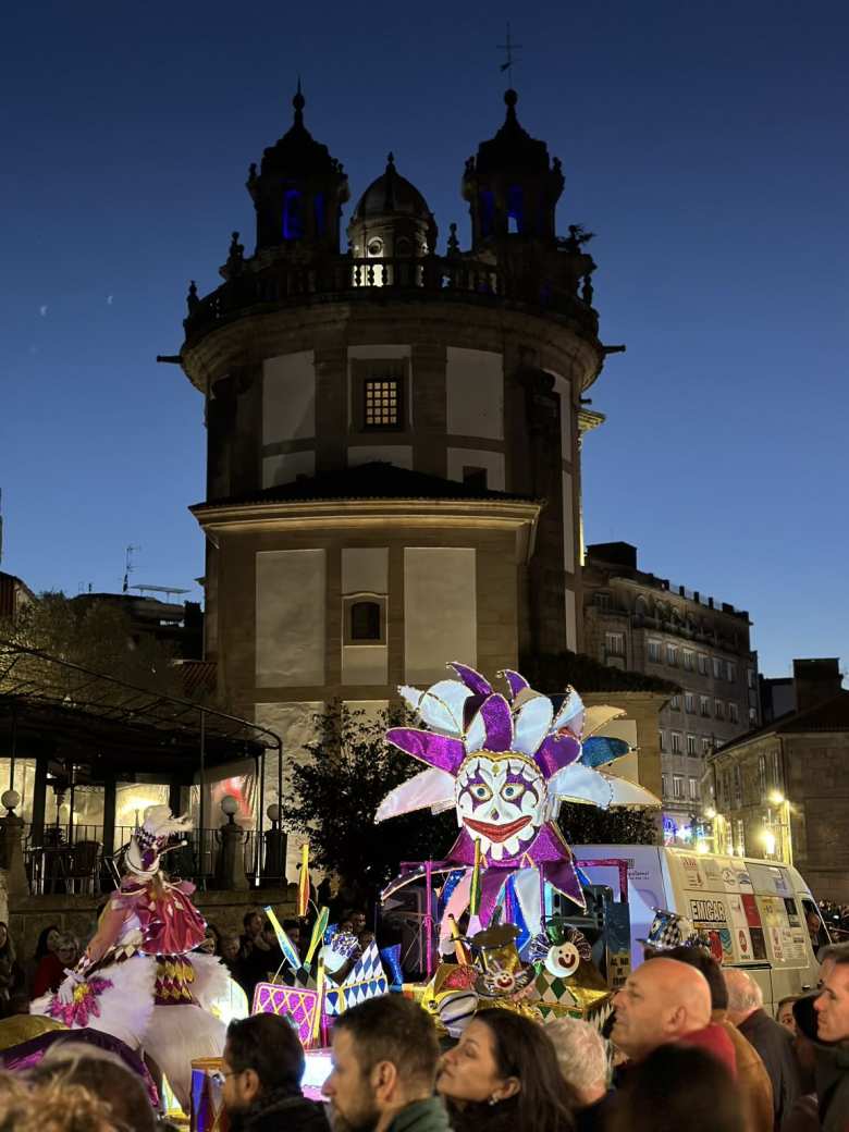 A "joker" character in the Entroido parade in front of the Iglesia de la Virgen Peregrina.