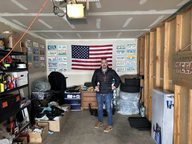 Manuel's garage had an American flag and lots of license plates from different states that he has collected.