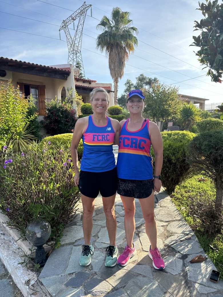Kate and Mel at the villa wearing matching FCRC running jerseys.