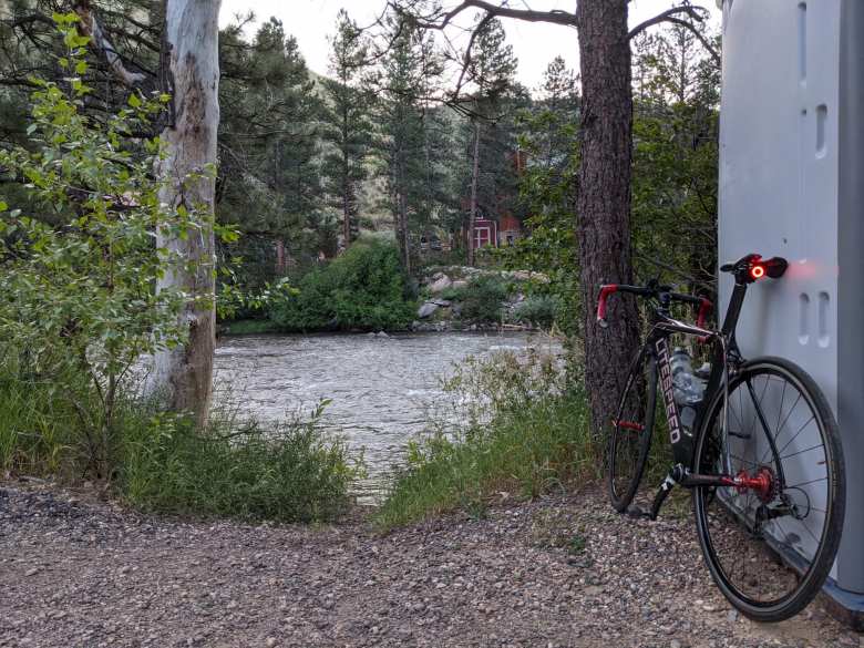 Poudre River, black Litespeed Archon C2 with rear taillight, grey port-a-potty