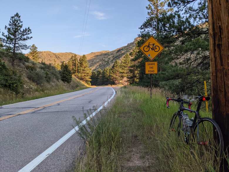 Poudre Canyon, yellow signs of bicycle and "share the road"