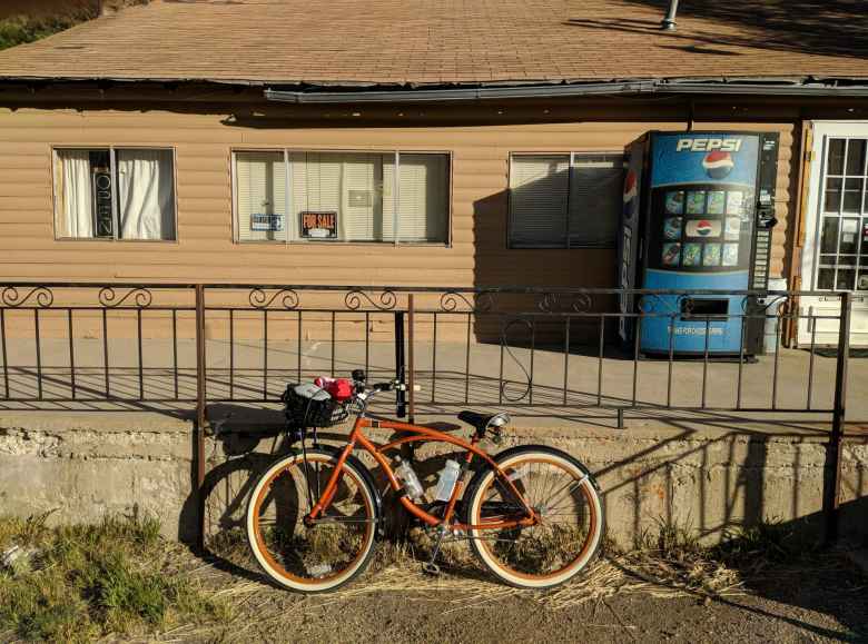 bronze Huffy Cranbrook Cruiser in front of store with vending machine