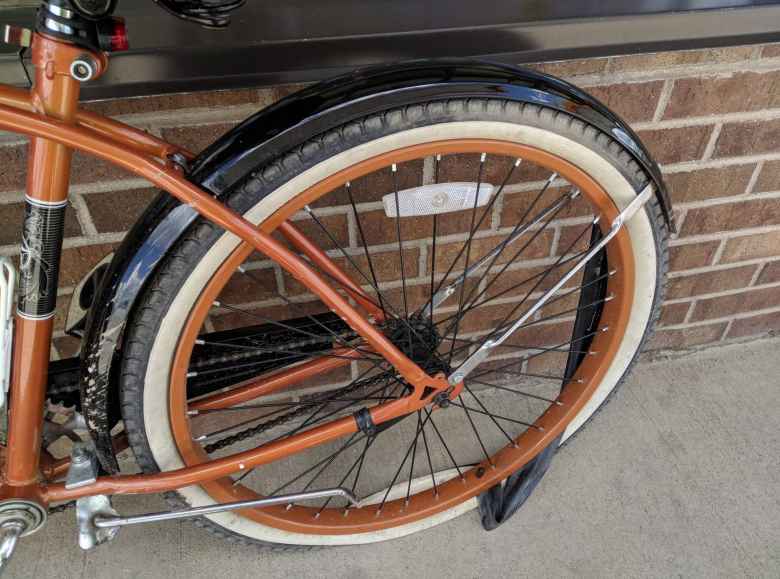 bronze Huffy Cranbrook Cruiser, tube outside of flat rear tire