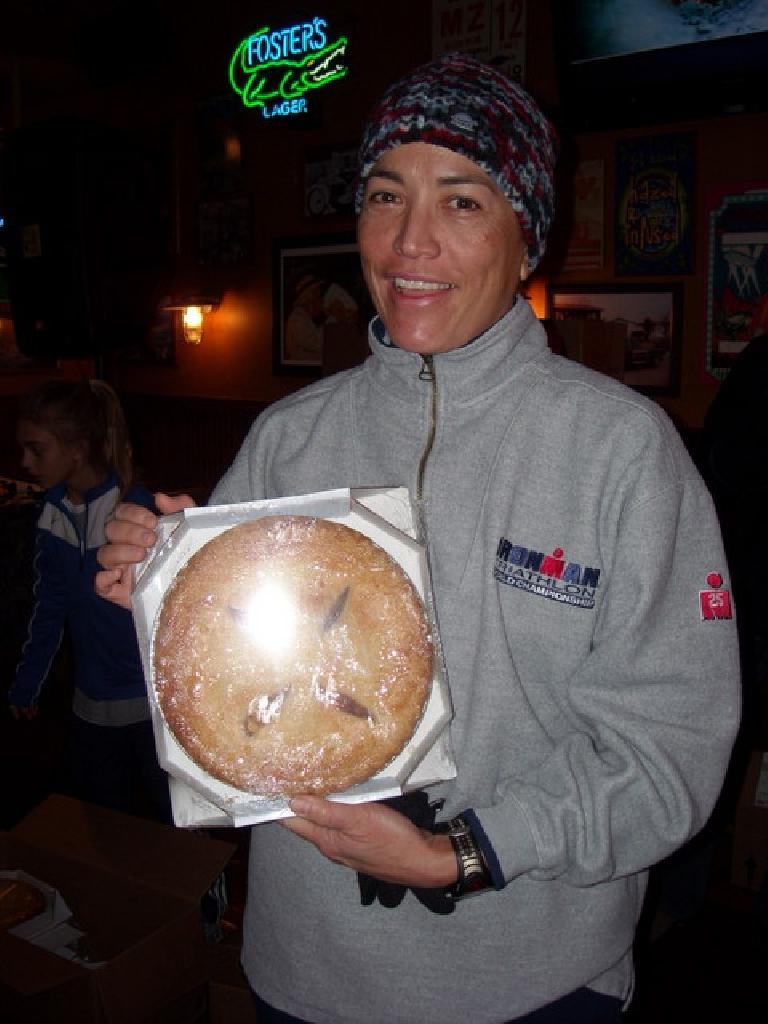 Diana Hassel wearing an Ironman sweatshirt and holding a pie