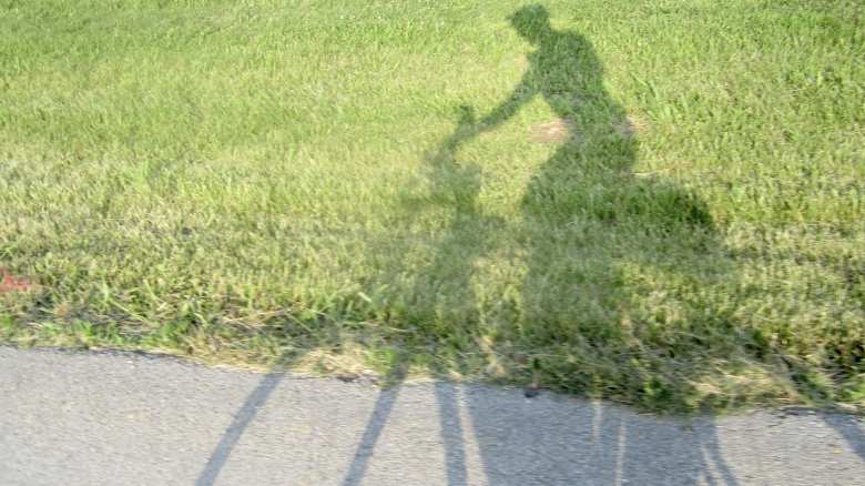 Unable to hold his head up anymore—a condition called Shermer's Neck—Felix wong raised his aerobars to a vertical position so that he could ride upright to see the road better, as seen in this shadow. He still had over 1000 miles to go.
