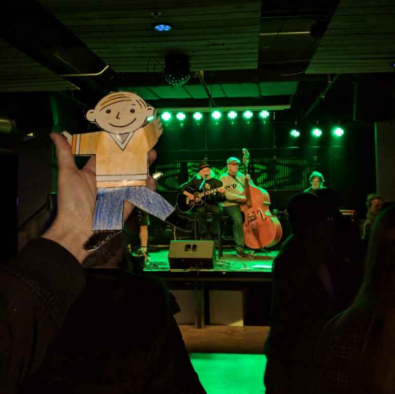 Flat Stanley listening to live music inside The Artery.
