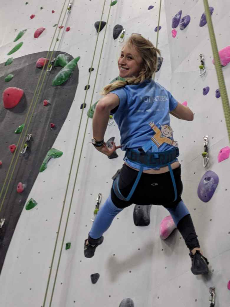 Emily climbing with Flat Stanley inside the new Whetstone climbing gym.