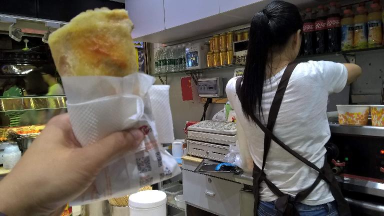 A fried dinner wrap made at a small restaurant off the Shangxiajiu Pedestrian Street in Guangzhou, China.